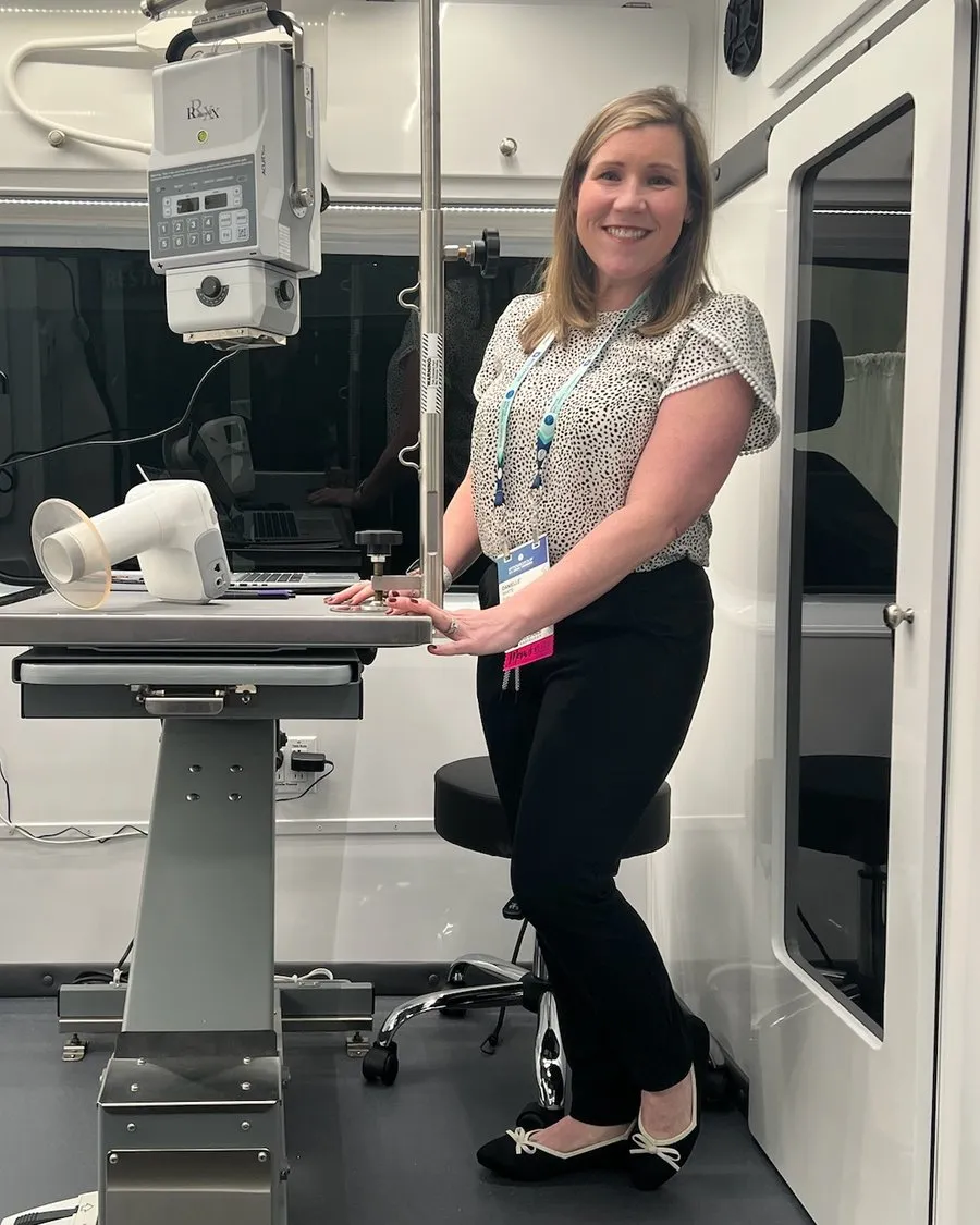 Dr. Danielle' White smiling inside the Wild Magnolia mobile veterinary unit